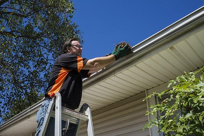 a damaged gutter getting a much-needed repair in Bingham Farms